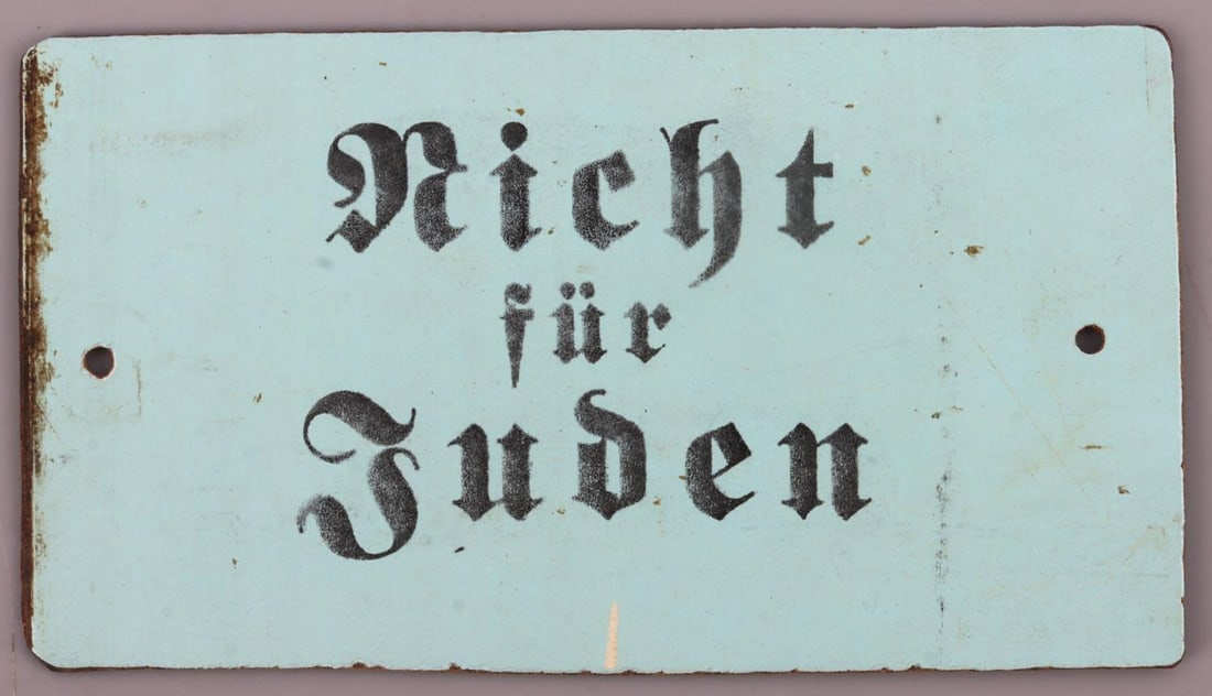 ANTI-SEMITIC PLAQUE FROM CLOSED MUSEUM IN UKRAINE: Painted "Nicht Fur Juden" on plaque which translates "Not for Jews". Back of plaque features a tag from a closed museum in Ukraine. Some discoloring and loss of finish is present; overall in good to v