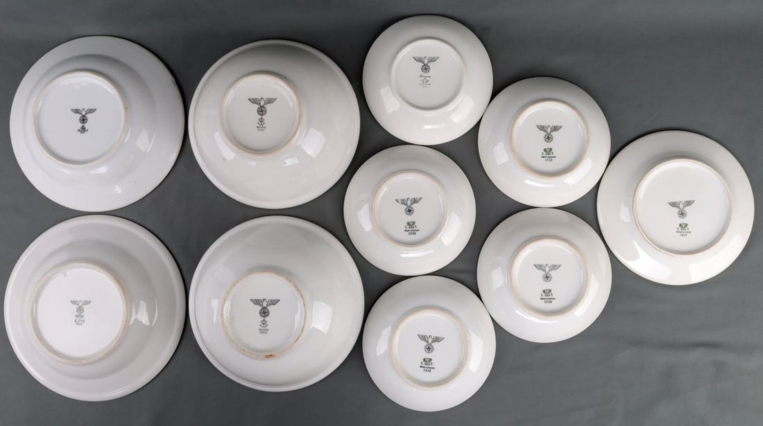 10 WWII GERMAN REICH NSDAP PORCELAIN PLATE & BOWLS: Lot of ten (10) WWII German Reich NSDAP party porcelain dinnerware including eight plates and two bowls. Each plates' underside features the NSDAP/Wehrmacht eagle insignia stamped. The manufacturers o