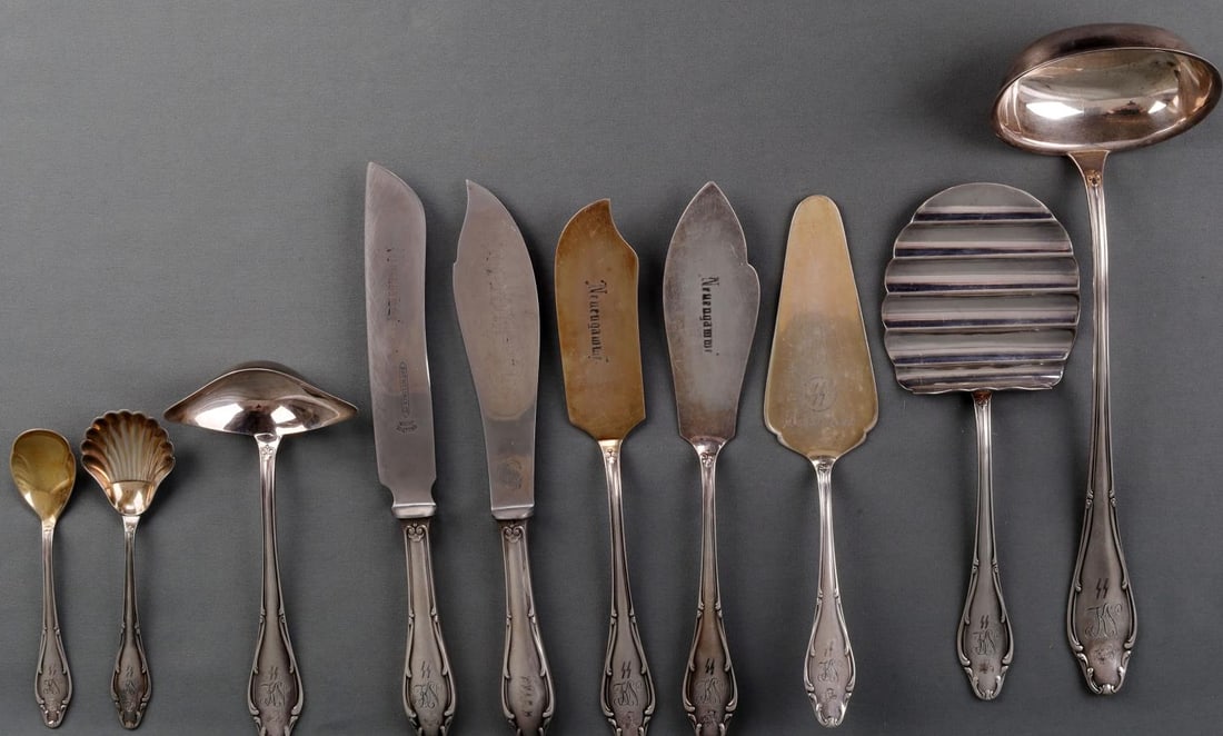 10 WWII GERMAN REICH WAFFEN SS SILVERWARE UTENSILS: Lot of ten (10) WWII German Reich Waffen-SS Silverware serving utensils including various spoons and knives like a ladle, cake knives, cutting knives, and serving spoons. Each utensils handle features