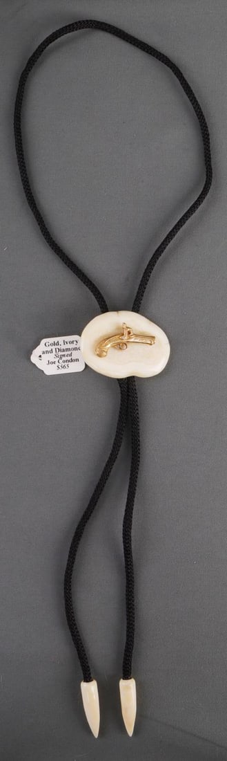 JOE CONDONE 14K GOLD DIAMOND WALRUS TUSK BOLO TIE: Philadelphia Deringer acid tests for 14K gold and diamond accent electronically tests. Reverse is signed "9/80 Joe Condon Las Vegas, NV". In very good condition. Deminimus exempt, no international shi