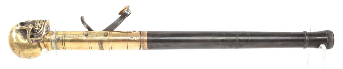 DAY'S PATENT TRUNCHEON PERCUSSION PISTOL: Days patent under-hammer breech loading percussion rifle with brass skull top. It measures 16.5 inches. Blued steel with brass overlay. Bore is in pore condition. Bore measures 11mm. No international 
