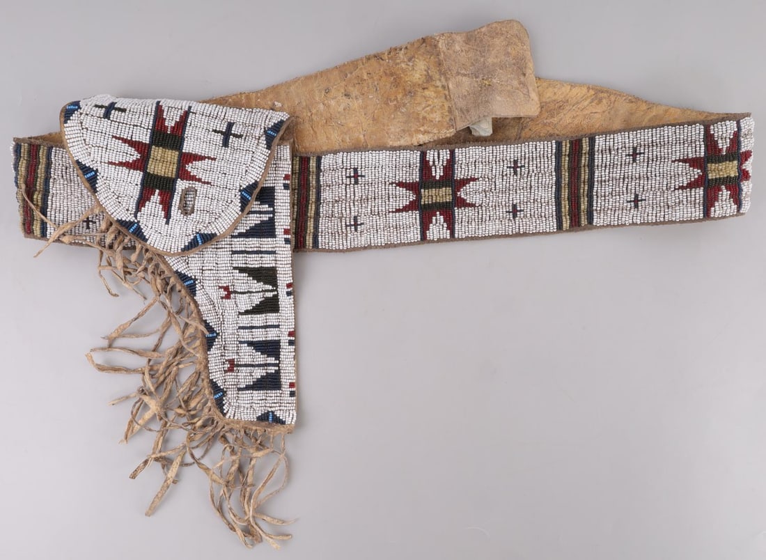 SIOUX TRIBE COLT SINGLE ACTION ARMY BEADED HOLSTER: Rare Native American Sioux tribe beaded holster. For a Colt Single Action Army revolver. Brain tanned leather with intricate bead work. It measures 47 inches long. Very good condition. This lot has a 