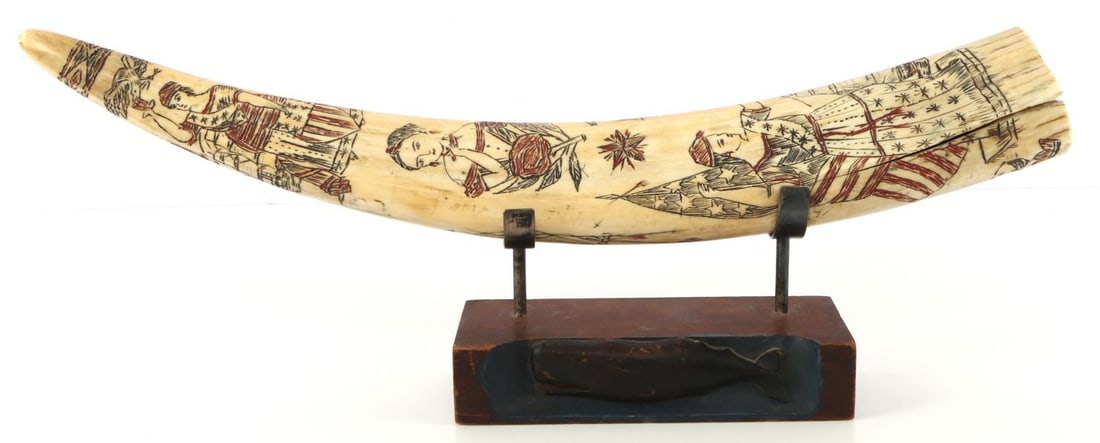 ANTIQUE WALRUS TUSK SCRIMSHAW WITH WHALE STAND: Large and long 18 inch near full scrimshaw, on early whale figure stand of carved wood, measuring 6 1/2 x 2 1/2 inches, exceptional detail and coloring, a period fracture of 4 3/4 inches, hardly detra