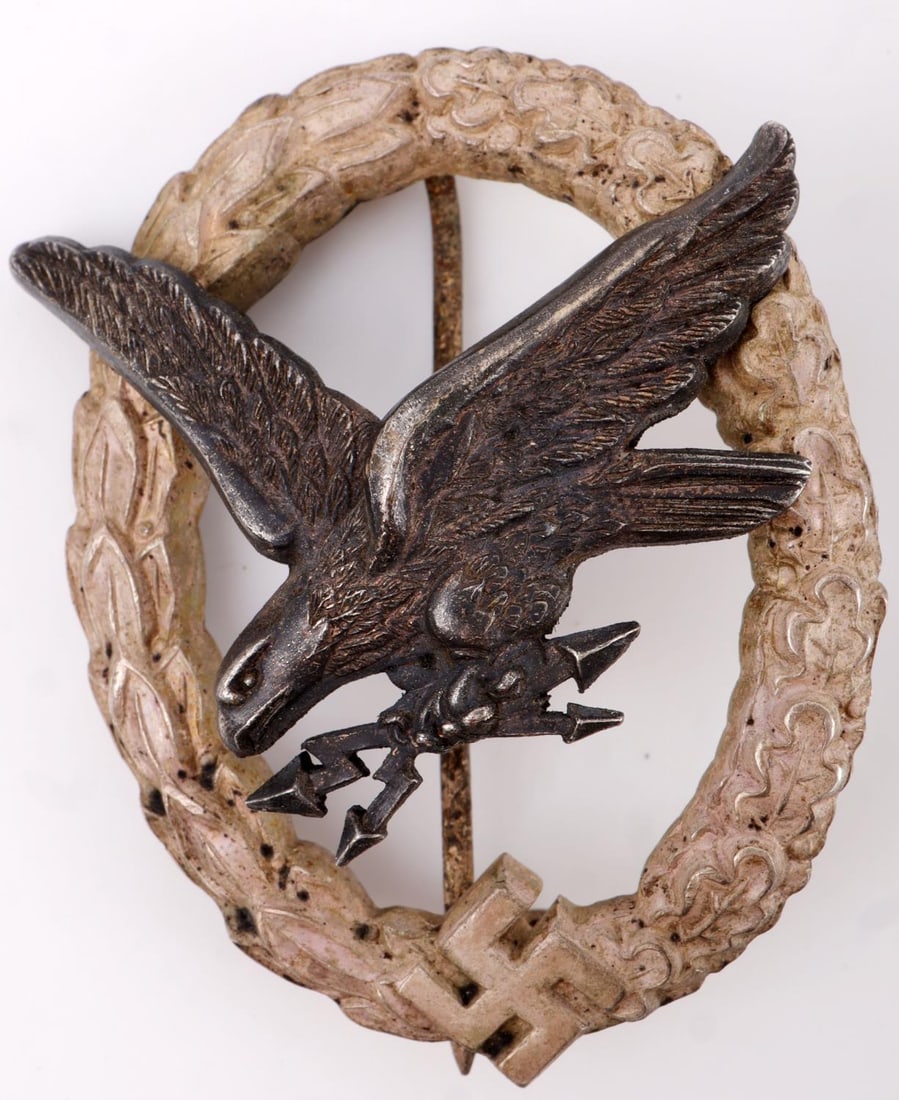 WWII GERMAN REICH LUFTWAFFE AIR RADIO GUNNER BADGE: WWII German Reich Luftwaffe Air Radio Operator and Air Gunner badge. Reverse features a vertical pinback with a manufacturer stamp, "G.H. OSANG DRESDEN". Outer wreath on badge acid tests for silver. B