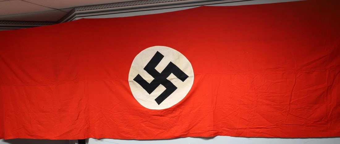 WWII GERMAN REICH 16 FEET NSDAP BANNER FLAG: WWII German Reich NSDAP party banner flag. Approx. size is 16 feet and four inches (L) X 4 feet and 8 inches (W). Machine-sewn, multi-piece construction. Does not fluoresce. Top left corner stamped, "