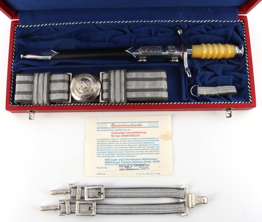 EAST GERMAN COLD WAR BOXED AS NEW DAGGER: Original dagger in it original fitted box with belt hanger and original paperwork, box measures 17 X 7 X 2 inches. Near mint condition.