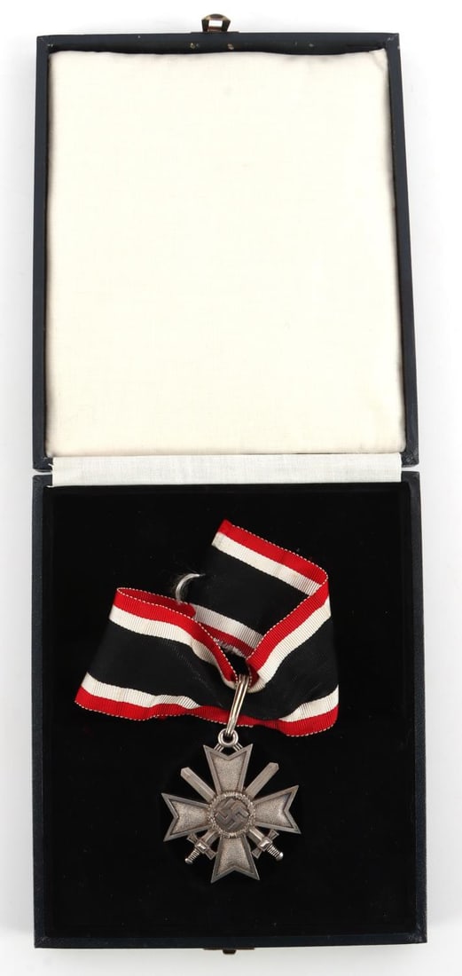 WWII GERMAN KNIGHTS CROSS TO WAR MERIT W CASE: Front shows a swastika in the center of a four armed maltese cross. Pair of crossed swords in the background. Reverse side is dated 1939. Includes the oblong suspension loop at the top with ribbon. Th