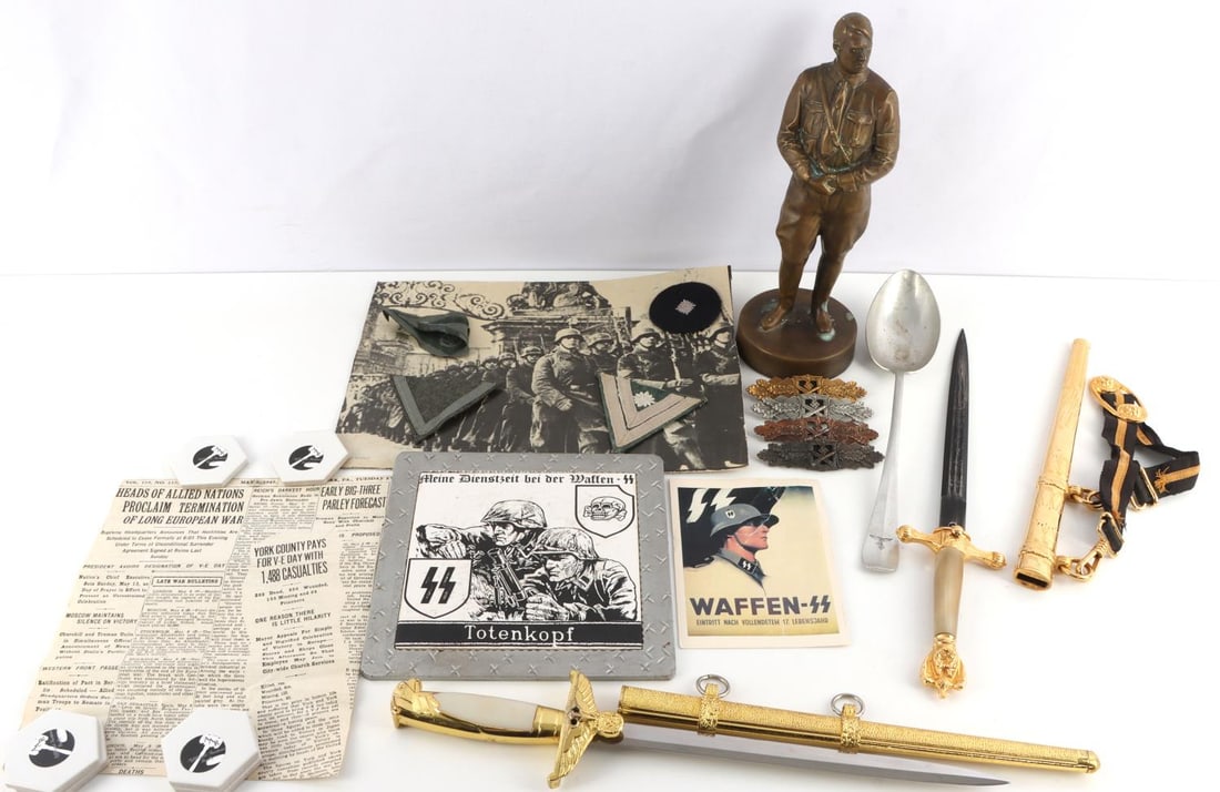 WWII GERMAN THIRD REICH MISCELLANEA LOT OF 15: Lot of 15 WWII German Third Reich items. Pair of daggers, 4 badges, 4 uniform insignia, statue, spoon and more. Unauthenticated, sold as-is.