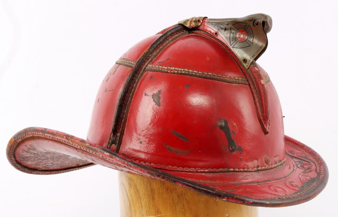 CAIRNS & BROS 650 SEAMED LEATHER FIRE HELMET: Four ribbed. From New York. Measures 14 X 10 5/8 inches. Very good condition.