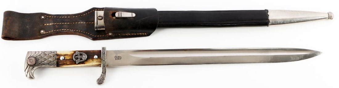WWII GERMAN THIRD REICH POLICE DRESS BAYONET: Nickel plated steel blade. Stag grip. WKC marked. Comes with leather scabbard and frog. Measures 19 inches overall in scabbard.