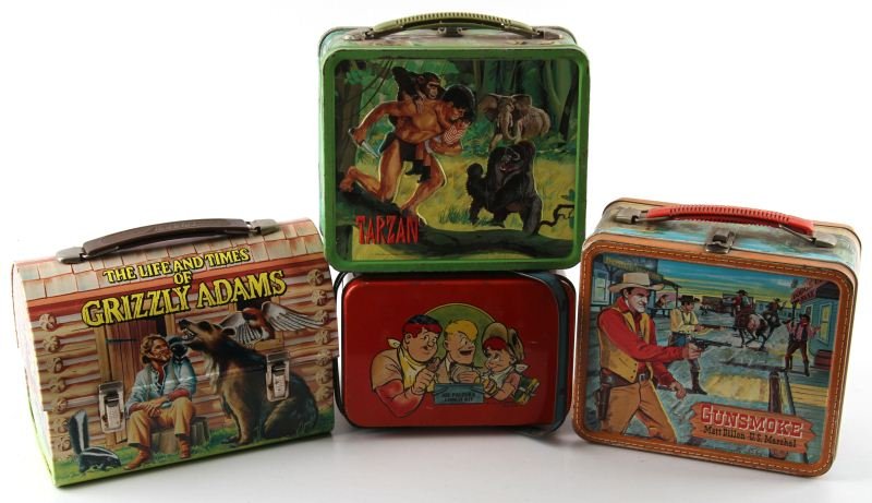 MIXED LOT OF FOUR ANTIQUE LUNCHBOXES: Mixed lot of four antique lunchboxes, to include: 1977 Grizzly Adams (with thermos), 1948 Joe Palooka Lunch Kit, 1959 Gunsmoke - Matt Dillon U.S. Marshal, and 1966 Tarzan. All show natural wear from a
