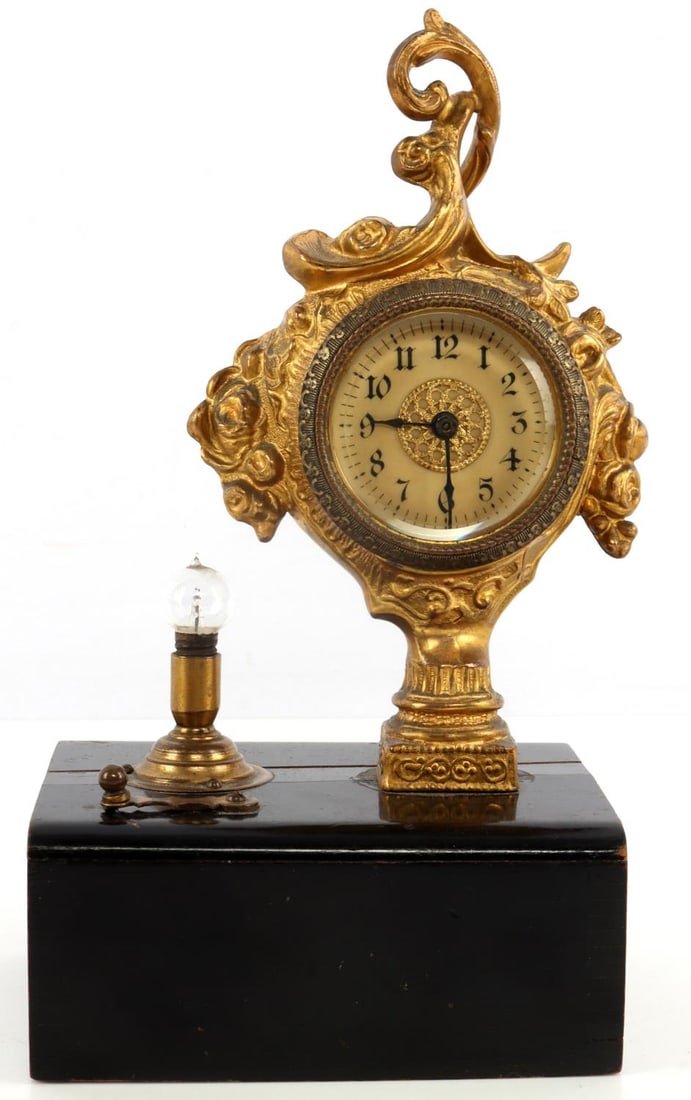 ANTIQUE FRENCH LIGHT CLOCK IN BRASS: Brass gilt clock with battery operated light. Cannot test as batteries are degraded. It measures 8 3/4 X 3 3/4 X 4 3.4 inches.