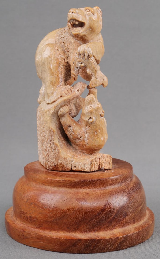 CARVED WALRUS TUSK 2 BEARS FISHING FIGUREEN: Hand carving of 2 bears catching fish figureen. Carved out of walrus tusk and on a wood base. Stands 5 1/2 inches X 3 1/2 inches. In very good condition with no chipping or cracks.