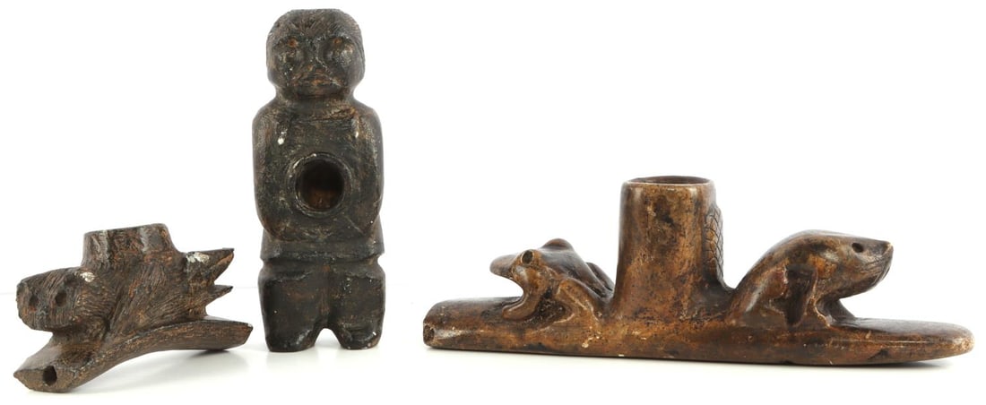 HOMAGE NATIVE AMERICAN EFFIGY PIPE LOT OF 3: Lot of three (3) homage stone carved artifacts. Animal effigy pipe with frog and badger motif (3 X 9.25 X 2.25 inches). Human effigy pipe (1.75 X 6 X 2.5 inches). Animal effigy pipe (2.5 X 4 X 1.75 in