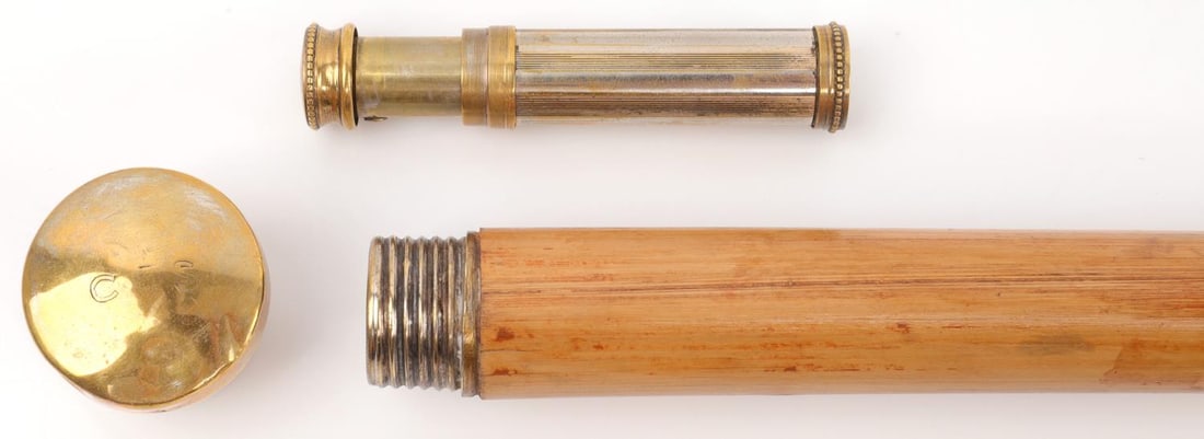 WALKING STICK WITH FRENCH PERFUME ATOMIZER: Wood shaft with ferule and gold toned top. Unscrews to reveal a perfume atomizer. It measures 32 1/2 inches. Very good condition.