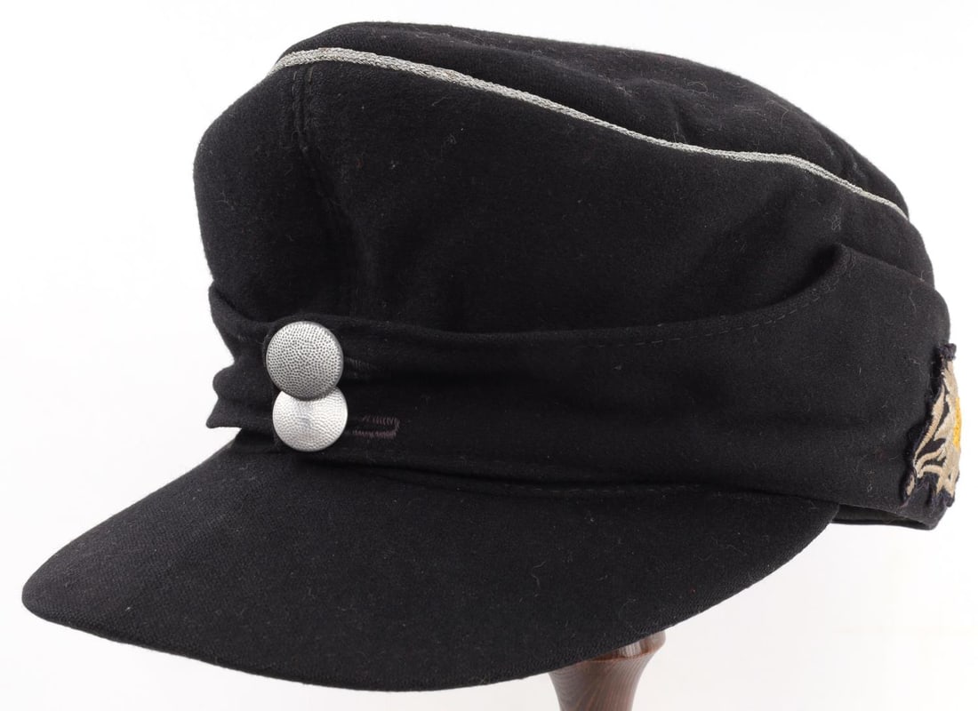 WWII GERMAN REICH SS MOUNTAIN TROOP M43 FIELD CAP: WWII German Reich SS Mountain Troop division M43 field cap. Field cap features two (2) pebbled buttons, silver piping, and an edelweiss patch on the left side of cap. No markings to interior of the fi