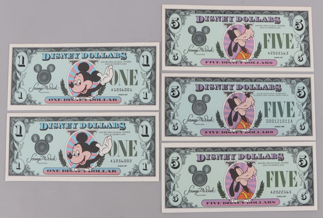 5 1987 SERIES DISNEY DOLLARS MICKEY & GOOFY UNC: Lot of five (5) Disney Dollars. All uncirculated. Three (3) Goofy $5 bills, 2 from 1987 (A2022163 & A2022165), 1 from 1988 (D00121011A). Two (2) Mickey $1 bills, (A1056001 & A1056002), both from 1987,