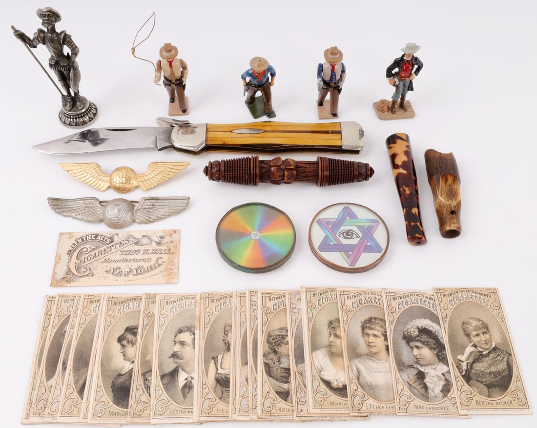 ANTIQUE LOT TOY COWBOY BETWEEN THE ACTS WINGS: The 4 lead cowboys are un-marked and measure 2 1/2 inches, 29 between the acts cigarette cards, U.S. Air Mail wing plus one other, opened 9-inch knife, Cheroot holder, non silver Don Quixote, and more
