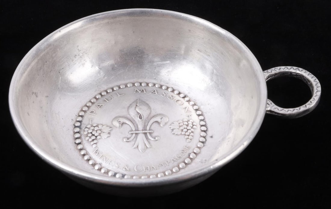 PAUL MASSON STERLING SILVER WINE TASTER TASTEVIN: Paul Masson Wines & Champagne sterling silver wine tasting cup. Stamped "Sterling" and tests for silver. Diameter 3.25 inches. 49 grams gross weight.. Weight: 49g This lot has a reserve.
