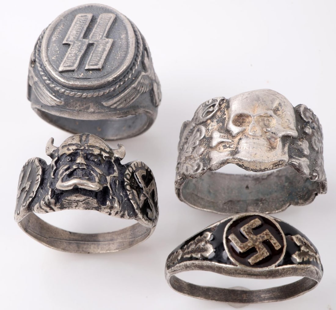 WWII GERMAN THIRD REICH SS SILVER RING LOT OF 4: 1 Waffen SS Division "Viking ring size 11 1/4. Waffen SS Runes ring size 9. Black enameled Swastika ring size 12 3/4. Anti-Partisan Warfare Totenkopf ring size 12 1/2. All in very good condition. Unau