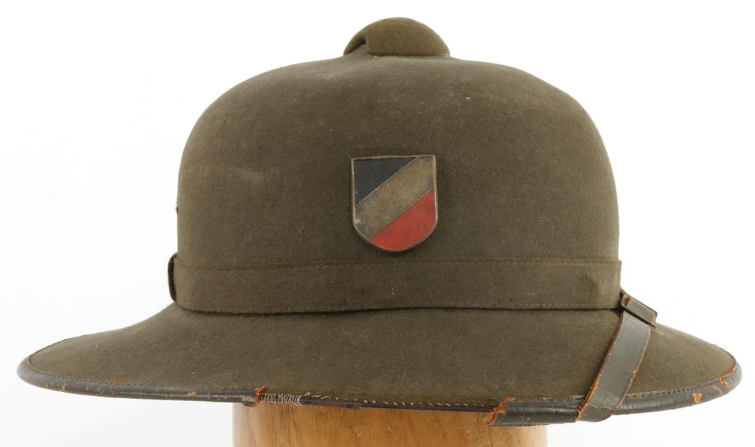WWII GERMAN THIRD REICH HEER TROPICAL PITH HELMET: WWII German Reich Heer Army Tropical Pith Helmet. Helmet features two (2) shields, right side features a German flag shield and left side has a Heer eagle insignia shield. Helmet has a leather chinstr