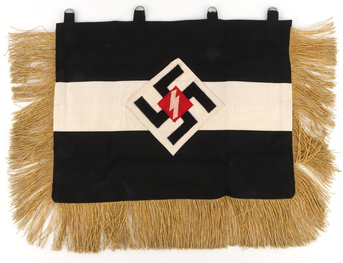 GERMAN THIRD REICH DEUTSCHE JUGEND BUGLE BANNER: Trumpet or bugle banner for the Deutsches Jugend division of the Hitlerjugend. Primarily black cloth with a gold fringe and a white stripe down the middle. In center is an angled swastika on a white d