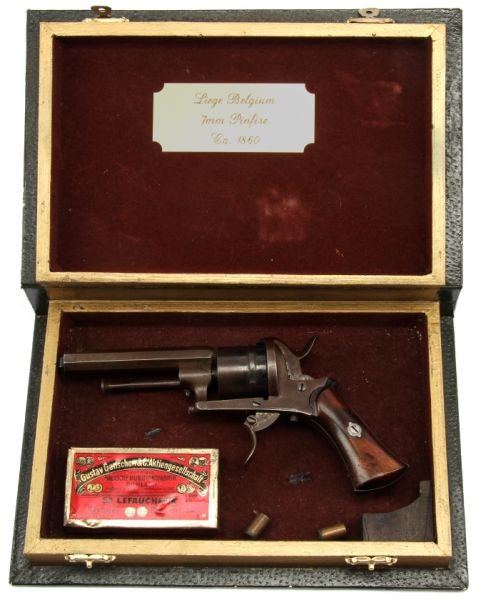 BELGIAN LEFAUCHEX STYLE PINFIRE REVOLVER IN BOOK: 19th Century Belgian Lefaucheux style pinfire revolver in latching "book" style box (titled Gone With the Wind). Gun mounts to metal bar, with box of 7mm pinfire ammunition displayed below. Deep plum 