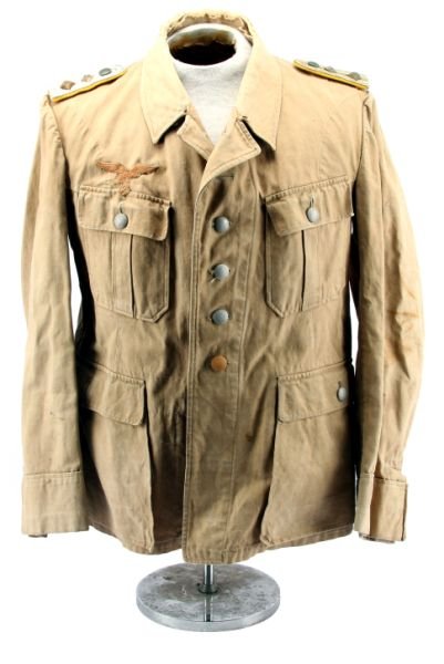 WWII GERMAN LUFTWAFFE AFRIKA KORPS SUMMER TUNIC: WWII German Luftwaffe Afrika Korps officer's 4 pocket summer tunic, with Luftwaffe eagle over right pocket, and Hauptmann [Flight Lieutenant] shoulder boards. Some fraying at collar and staining to sl