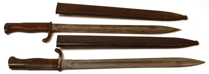 TWO GERMAN 98/05 BUTCHER BAYONETS: Lot of two German 1898 / 05 "Butcher" bayonets. First bayonet is marked "WAFFENFABRIK MAUSER A. G. OBERNDORF a. N." on ricasso. Blade is in very good condition, about 65% bluing remaining on scabbard,