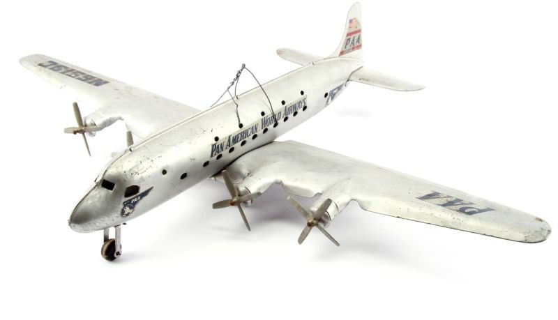 DELUXE MARX PAN AMERICAN PAA DC-4 TOY PLANE: This deluxe version of this 1950s toy. The props turn when pushed on the ground. 1940 early 1950s. Measures 22 inches long with a wingspan of 27.5 inches.