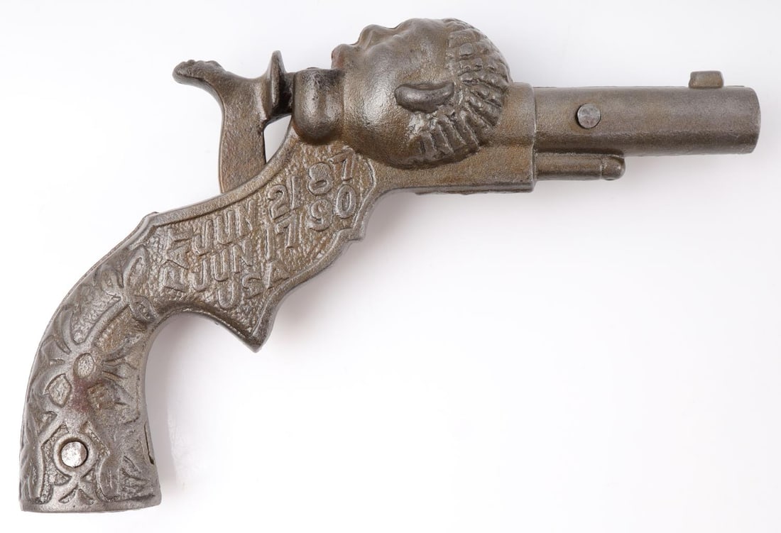 BLACK AMERICANA 19TH C SAMBO CAST IRON CAP GUN: Antique cast iron cap gun. Left side embossed with "SAMBO" and right side with "PAT JUN 21 87 June 17 90 USA." Very good condition. Functions without issue. Some pitting evident on hammer surface.