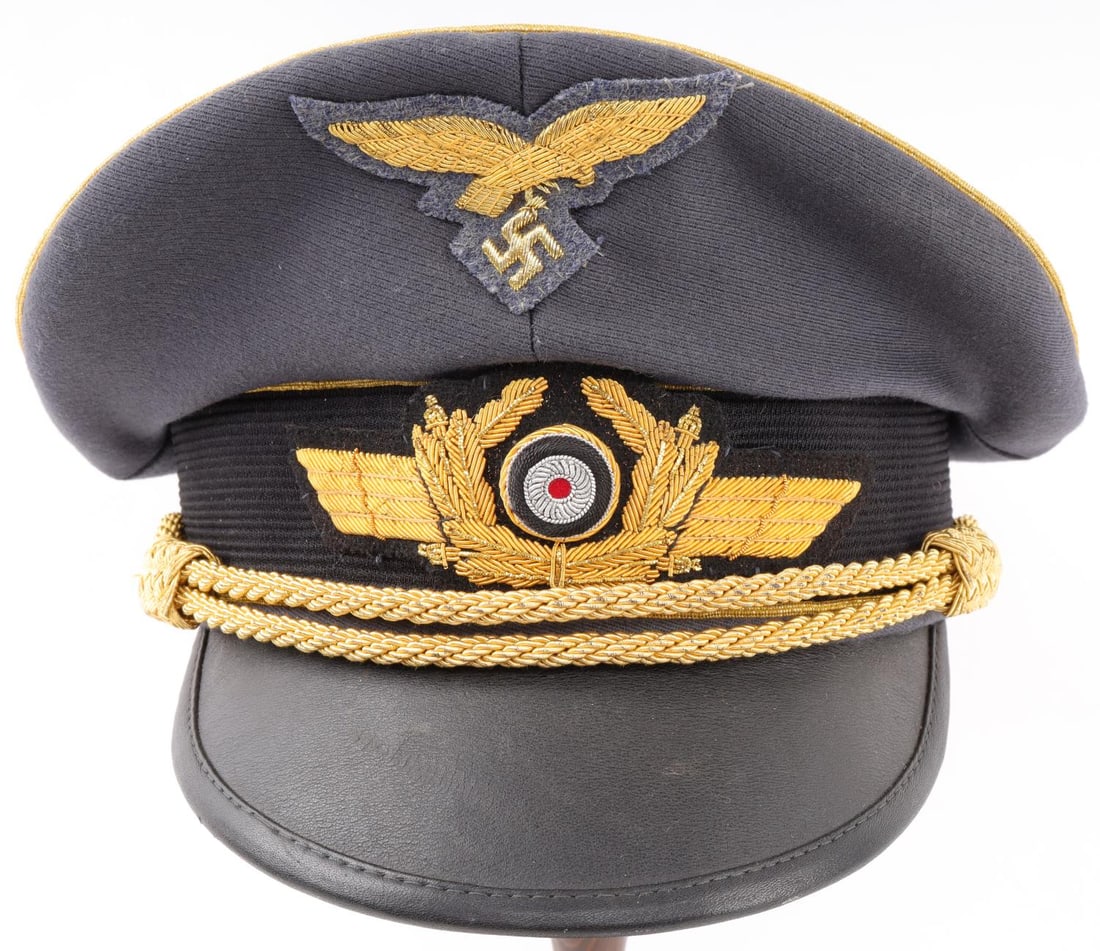 WWII GERMAN THIRD REICH LUFTWAFFE OFFICER VISOR: Non-fluorescing. Gold bullion cockade and Reichsadler patches. Leather headband. Interior size 58. Silk lining. Very good condition. Unauthenticated, sold as is.