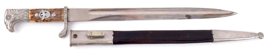 THIRD REICH POLICE DRESS BAYONET E&F HORSTER: Municipal police bayonet with scabbard. Bayonet has a steel blade and stag grip with nickel finger guard and pommel. Ricasso stamped "E. & F. Horster Solingen" with monogram on reverse. Finger guard a