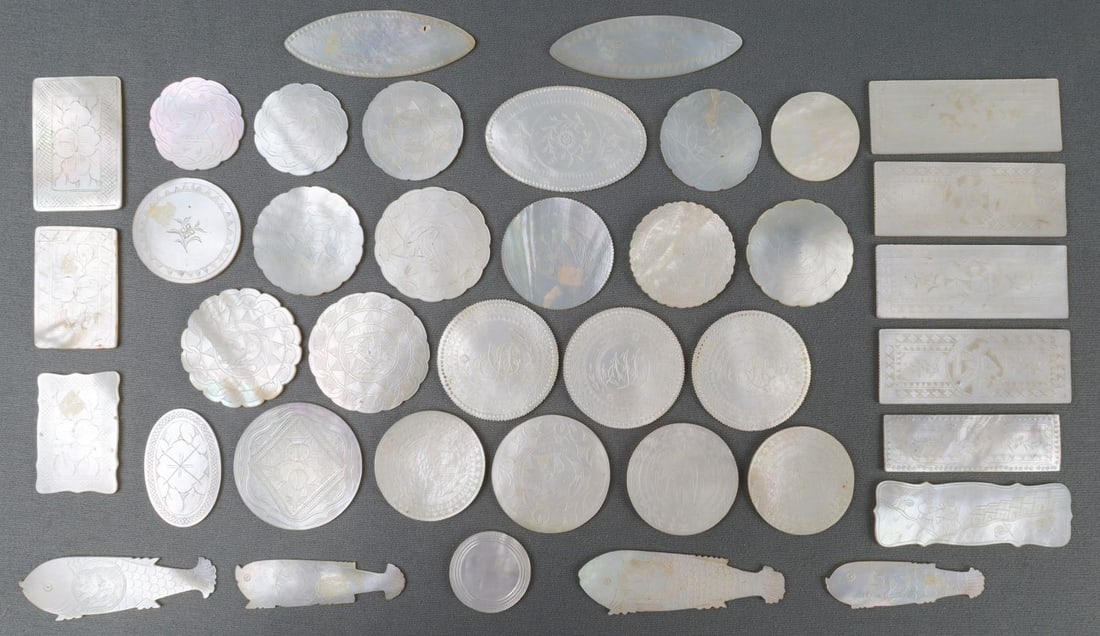 ANTIQUE 19TH CENTURY CHINESE MOTHER OF PEARL CHIPS: Lot of 39 assorted circular, rectangular, ovular, and fish shaped chips. Antique 19th Century Ming Chinese Mother of Pearl chips. Used throughout Western Europe as gaming and scoring pieces. Ranging f