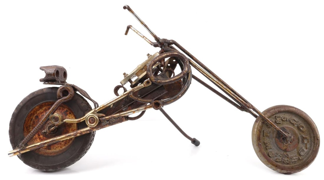 LINUS CORAGGIO SCRAP IRON SCULPTURE OF MOTORBIKE: Scrap iron statue depicting a motorbike. Statue is signed on rear tire by Linus Coraggio and dated to 2001. Approx. 14(H) X 29(L) X 7(W) inches. Very good condition.