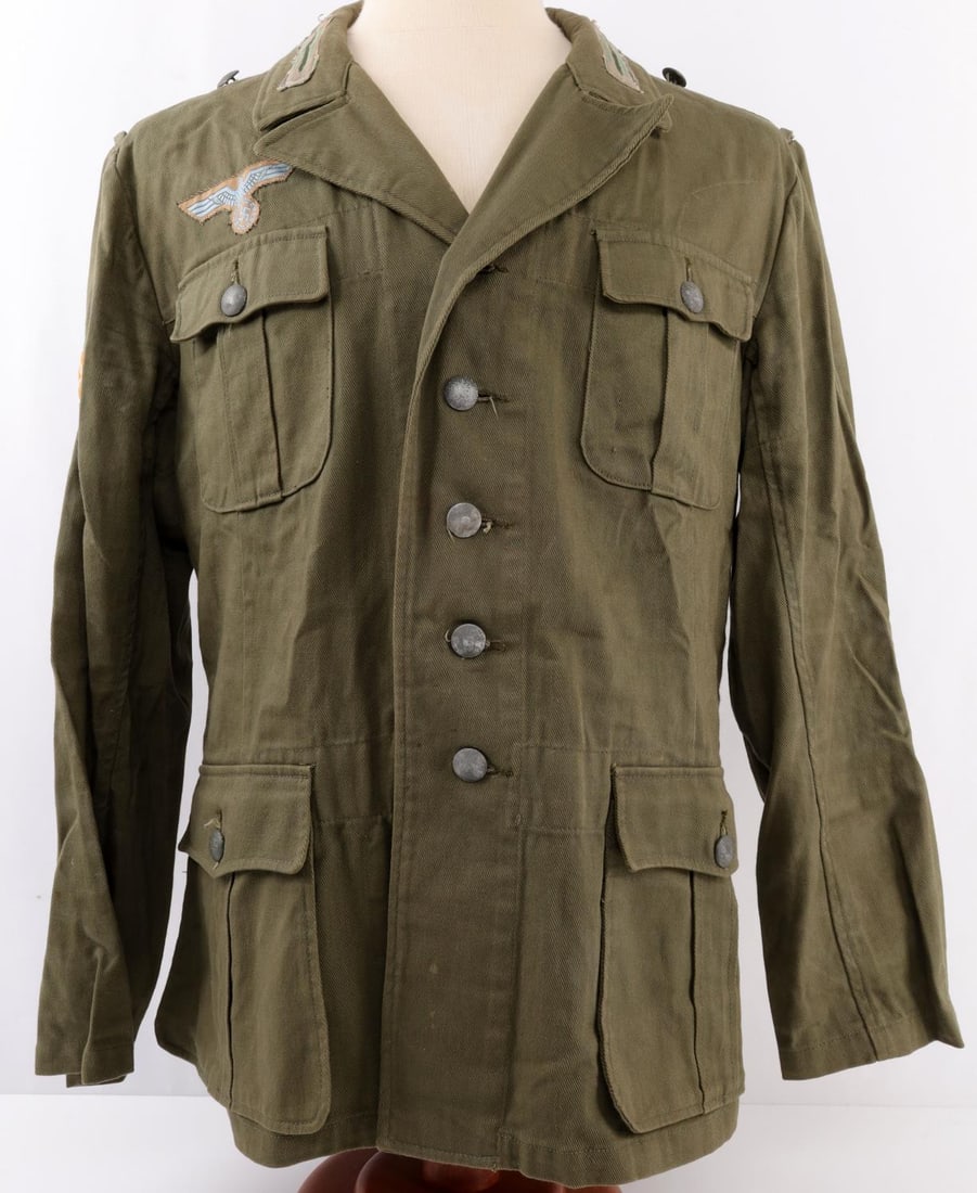 WWII GERMAN THIRD REICH PANZER GRENADIER TUNIC: Third Reich panzer grenadier tunic. Dark green color. Light blue on khaki reichsadler. Edelweiss on orange patch. Collar tabs feature a single dark green and two light green stripes. Patches do not fl