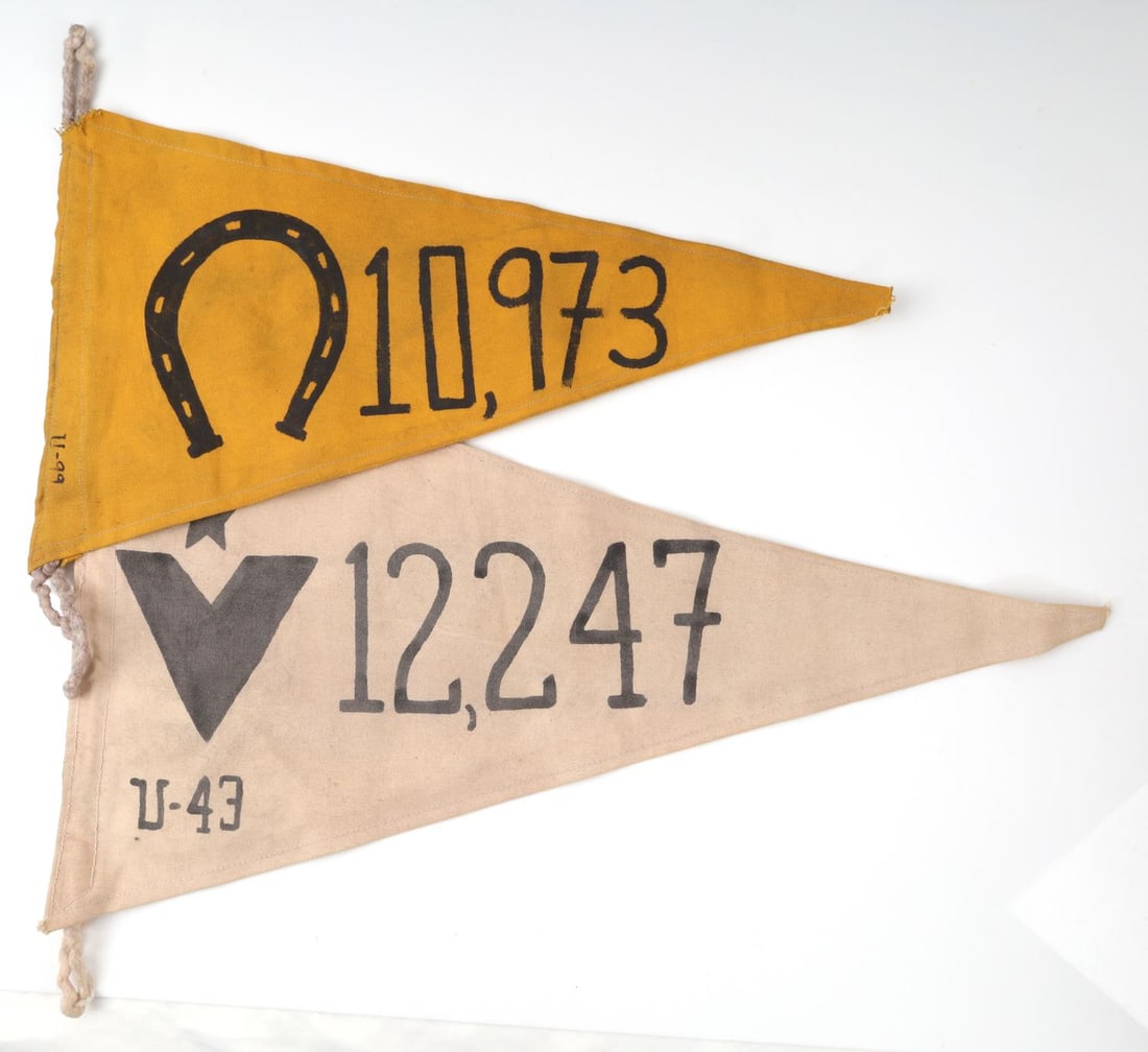 WWII GERMAN U-BOAT FLAG U-43 & U-99 LOT OF 2: Lot of two (2) pennant flags. The yellow flag has a painted horseshoe and, on the hoist, "U-99." 22X20 inches. The white flag has an inked insignia of a five-pointed star above a "V" and "U-43." 14X24