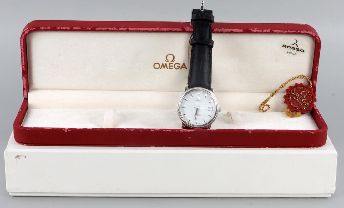 OMEGA AUTOMATIC CHRONOMETER WRIST WATCH W BOX: Stainless steel automatic Omega watch. Case measures 34 millimeters and 36 millimeters including crown. Band is Omega Brand black leather. Some wear from age on original box. Also includes manual and 