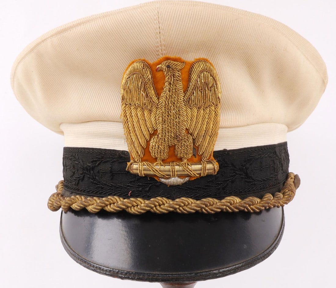 WWII ITALIAN FASCIST PNF HIGH OFFICIAL VISOR CAP: High leader's white top summer uniform visor cap. Gold bullion eagle insignia on yellow felt backing, embroidered black band, gold visor cord and brass buttons with Partito Nazionale Fascista symbol. 