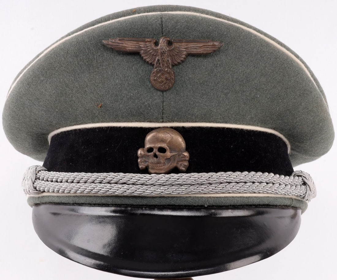 WWII GERMAN THIRD REICH SS OFFICER VISOR: Field grey cap with silvered zinc skull and Parteiadler. Non-fluorescing. Silk liner on interior. Size 7 1/8 inches. Parteiadler missing one pin. Very good condition otherwise.