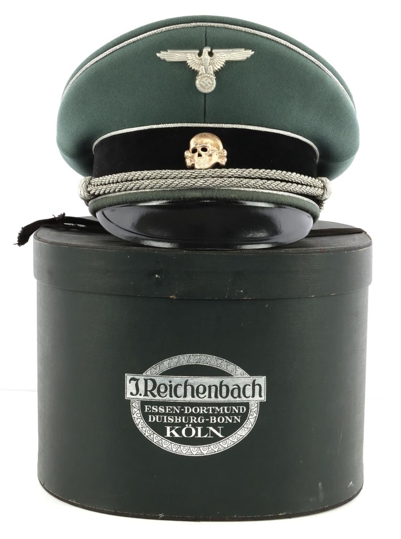 WWII GERMAN THIRD REICH WAFFEN-SS VISOR CAP BOXED: Waffen-SS officer's visor cap. Liner intact. 83X stamp in the front interior behind sweatband. Reichsadler and totenkopf pins on front. Silver bullion braid and silver piping on black. Plastic cellulo