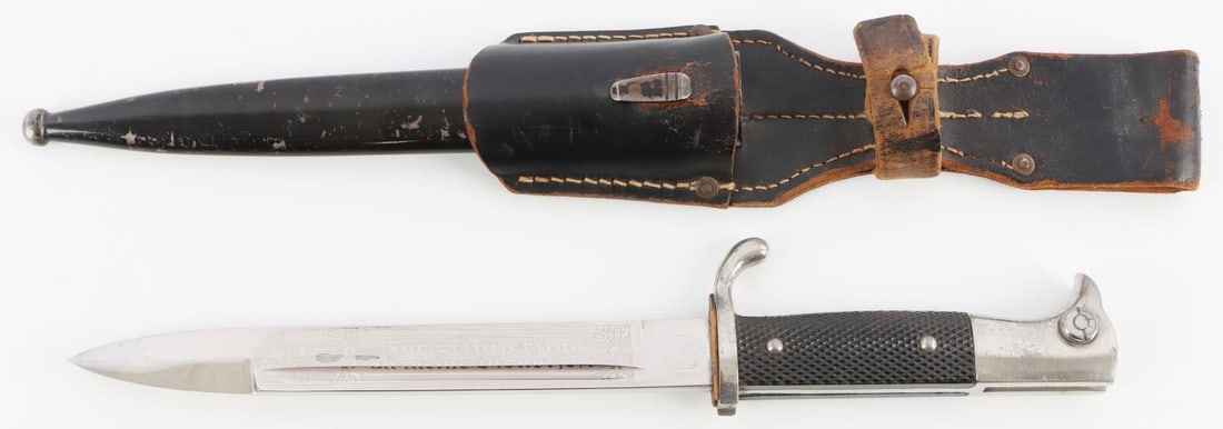 WWII GERMAN THIRD REICH K98 DRESS BAYONET: Engraved dress bayonet by Horster. Housed in steel scabbard. Bakelite grips. Push button is functional Comes with leather frog. Measures 13 5/8 inches in scabbard.