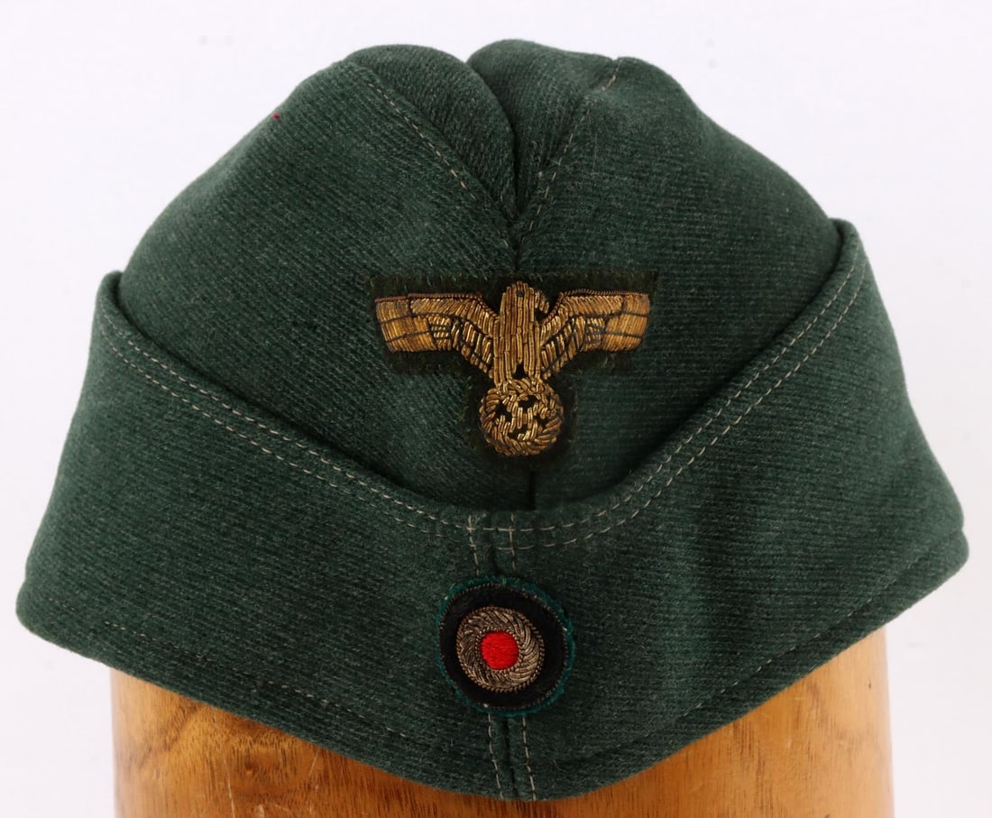 WWII GERMAN THIRD REICH HEER OVERSEAS CAP: Gold bullion Reichsadler patch and cockade. Minor fluorescing on patches. Wool construction. No ink stamp on interior. Measures 11 inches.