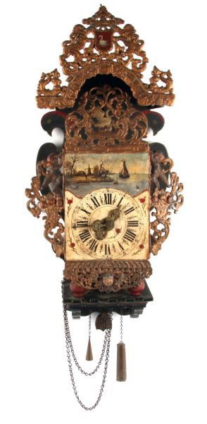 FINE 19TH CENTURY DUTCH WALL CLOCK: A finely painted wall clock featuring a landscape with boat and windmill. Wood frame with attached forged metal pierced panels. chain and weight driven with chime.