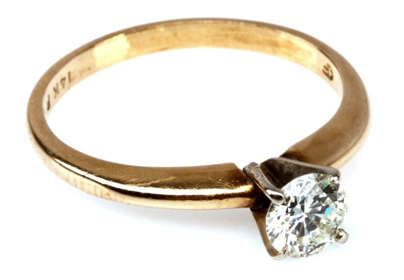 LADIES SOLITAIRE ENGAGEMENT RING: One 14K yellow gold ladies solitaire engagement ring, four prong white gold head containing one round brilliant cut diamond weighing approximately .50 carats. Color grade: H Clarity grade: SI2 Good ma