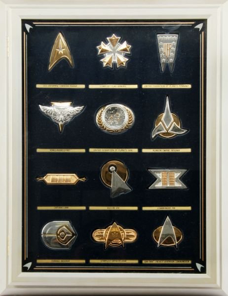 STAR TREK INSIGNIA COLLECTION SET 12 SILVER PIECES: The Official Star Trek Insignia Collection (Franklin Mint), includes twelve insignias minted in solid sterling silver, some with 24-karat plate. Consist of USS Enterprise Command, Starfleet Flag Admir
