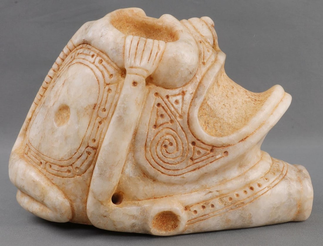 PUBLISHED TAINO PRECOLUMBIAN OUTSTANDING HEAD: Outstanding head with residual body. The hands grasp broad eye sockets while bird head designs are incised on cheeks and top of head. Nose is carved as a bird. Large face is incorporated into the back