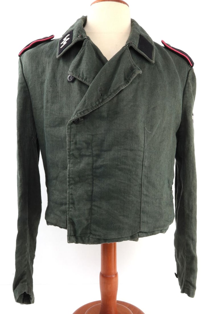 WWII GERMAN WAFFEN-SS ASSAULT GUNNER HBT WRAP: Waffen-SS Sturmgeschutze summer uniform tunic or "panzer wrapper." Grey-green herringbone twill fabric with liner of pale green herringbone silk. Liner has four (4) interior pockets and suspender stra