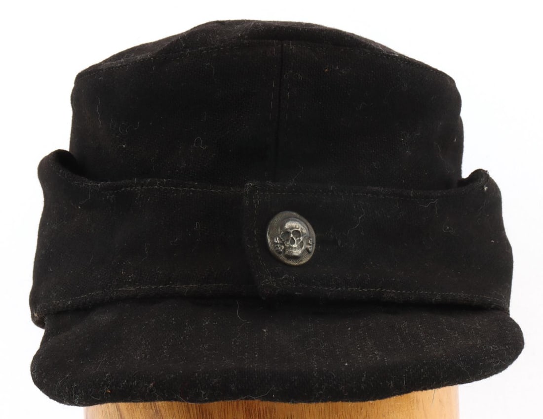 WWII GERMAN THIRD REICH SS M43 FIELD CAP: Black wool with 900 silver totenkopf button. Marked 900 and RZM. 11 inches long. Missing liner. This lot has a reserve.
