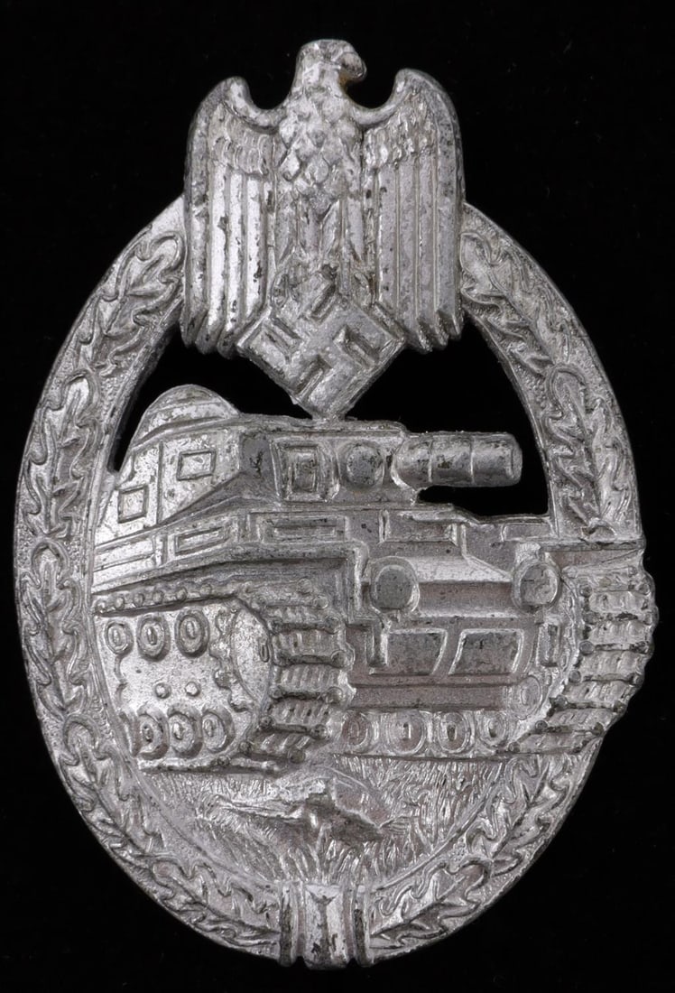 WWII GERMAN THIRD REICH PANZER ASSAULT BADGE: Wreath and Reichsadler surrounding a panzer. Straight hinge pin back. Marked for maker Friedrich Linden. 1.75 X 2.5 inches. Very good, original condition. This lot has a reserve.